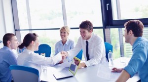 People shaking hands at a meeting